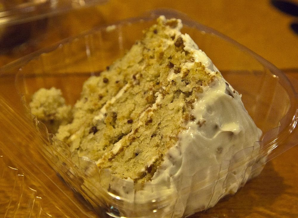 A tall slice of Italian cream cake with cream cheese frosting